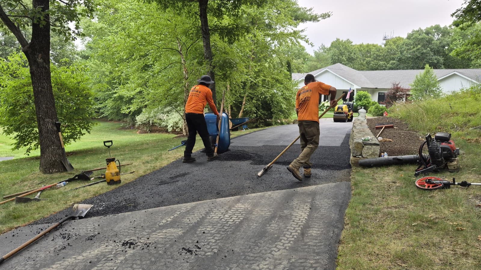 Marcelo Asphalt crew laying fresh hot asphalt on a driveway