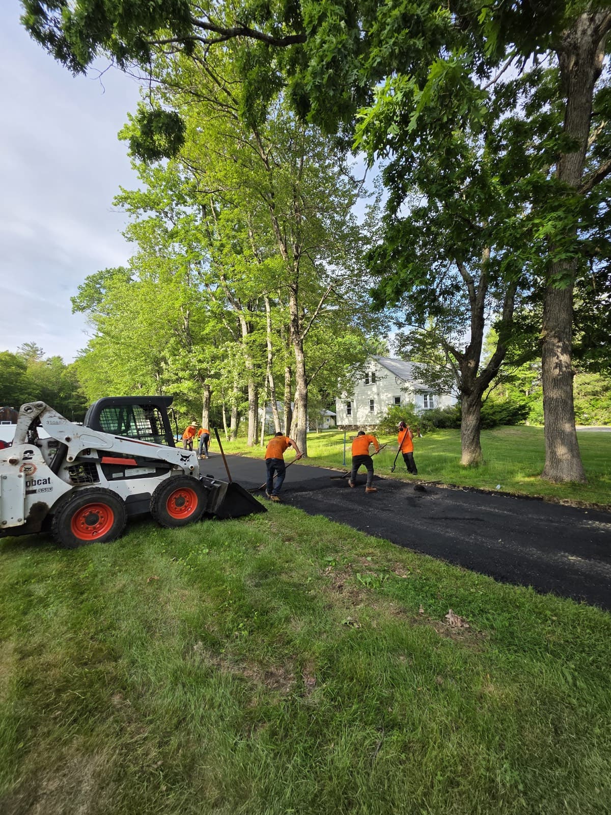 Marcelo Asphalt crew and skid steer paving a long driveway