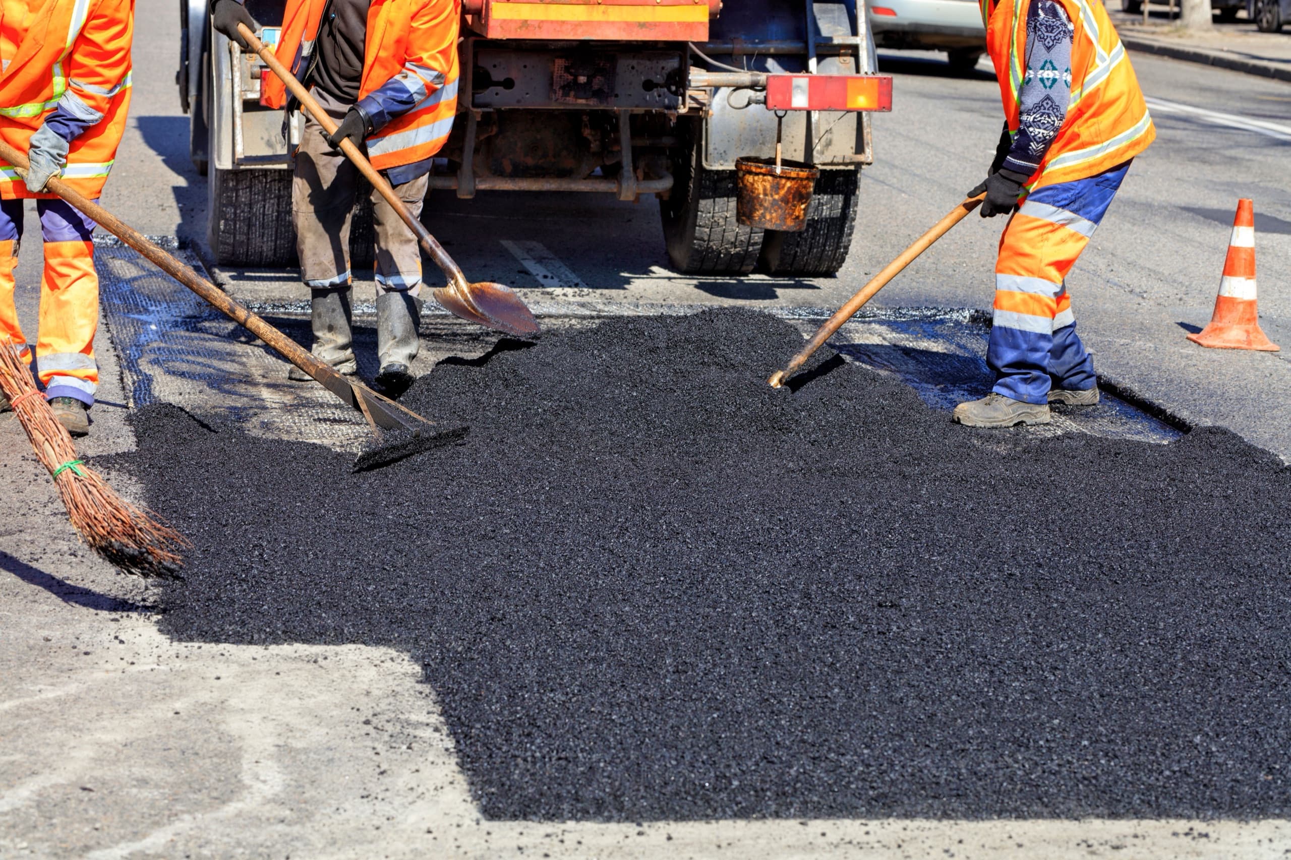 Crew repairing a pothole in the road